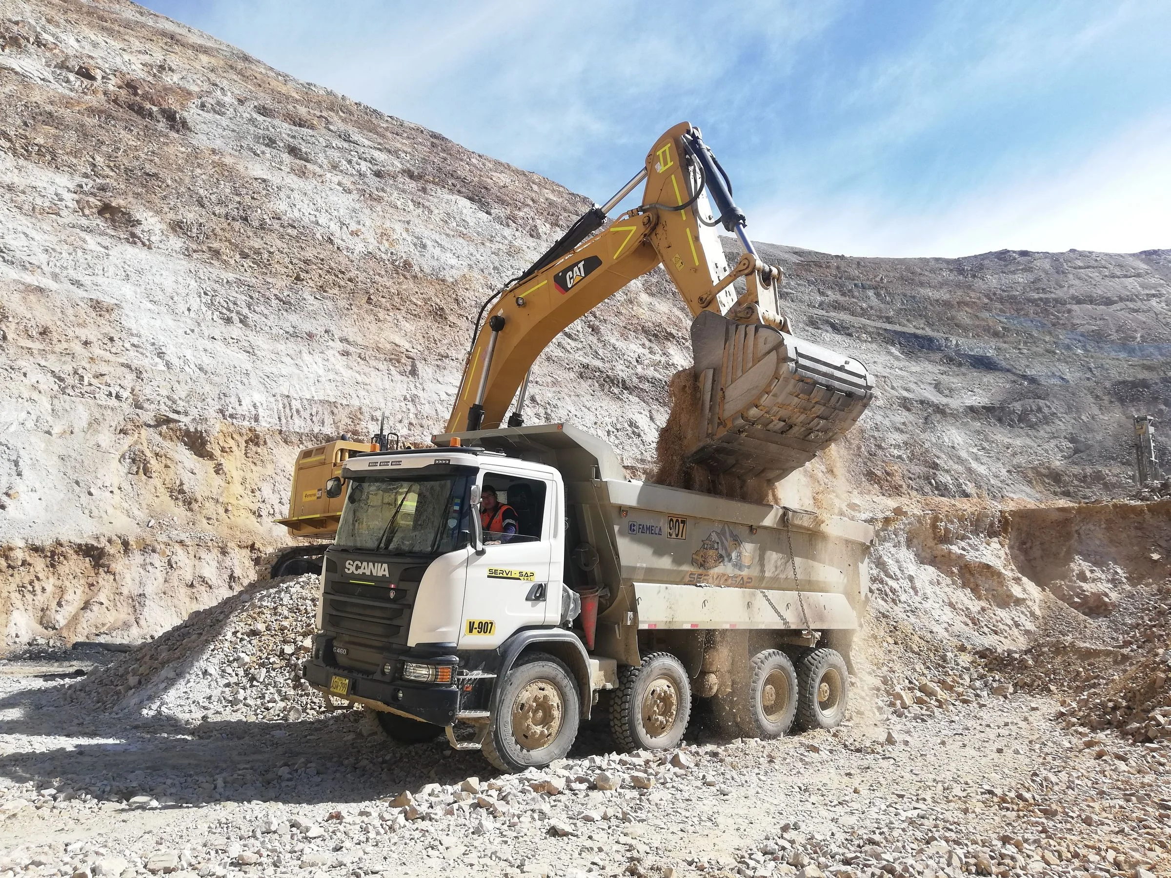 Illustrative industry photograph: excavator loading a dump truck