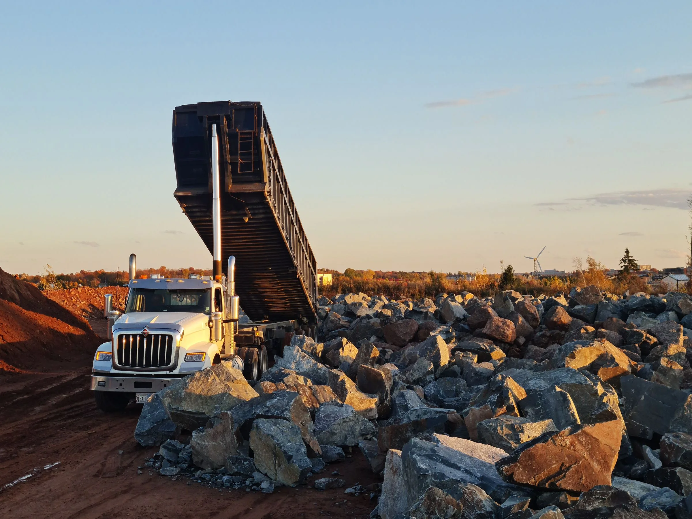 Illustrative industry photograph: truck unloading rocks